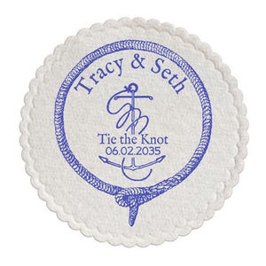 May include: A round, off-white coaster with a scalloped edge. The coaster features a blue nautical design with the names "Tracy & Seth" and the text "Tie the Knot 06.02.2035" encircling an anchor.