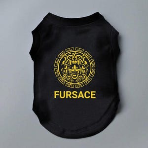 Black Dog shirt with the word FURSACE printed on it in yellow. The face in the logo is of a dog, incorporating dog ears and a smiling expression. The T-Shirt is designed for dogs, playing on the designer fashion brand in a humorous way.