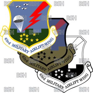 May include: A military emblem with a shield design. It features a blue sky, a red lightning bolt, and three white aeroplanes. The text reads "63rd MILITARY AIRLIFT WING".