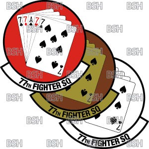 May include: A red, white and brown circular patch with the text "77th Fighter SQ" repeated three times. The patch features a stylised image of playing cards with the text "77" and the Ace of Spades.