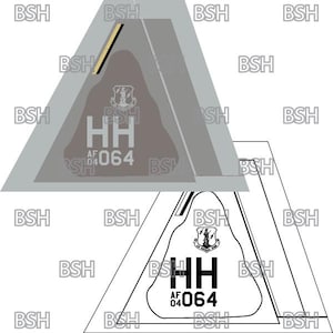May include: A gray and white triangle-shaped patch with the text "HH AF 064" and a stylized Air Force emblem. The patch is outlined in black.