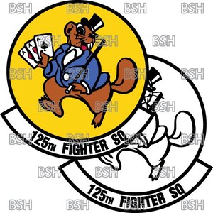 May include: A yellow and white circular patch with a black outline. The patch features a cartoon beaver wearing a top hat and a blue suit holding a deck of cards. The text "125th Fighter Sq" is written in black on the patch.