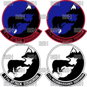 May include: Four different versions of a military squadron patch. The patch features a black silhouette of a bear standing on a mountain with a red and white snow cap. The words "17th Attack Squadron" and "17th Reconnaissance Squadron" are written in a red arc around the bear. Two patches have a blue background and two patches have a white background.