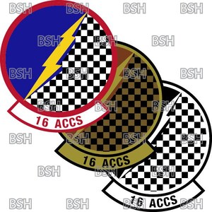 May include: A black and white checkered circle with a yellow lightning bolt and the text "16 ACCS" in red and white. The circle is surrounded by a red ring with a white outline. The circle is also surrounded by a black and gold checkered circle with the text "16 ACCS" in white.