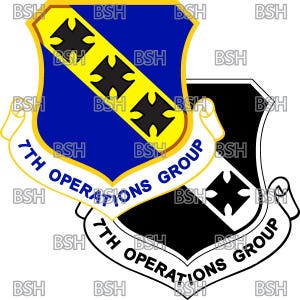 May include: A blue and yellow shield with three black crosses and the text "7th Operations Group" in a white banner. The shield is superimposed on a black and white shield with a black cross and the text "7th Operations Group" in a white banner.