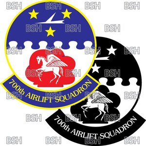 May include: A black and white emblem with a red and white winged horse. The emblem is surrounded by a blue and yellow circle with the text "700th AIRLIFT SQUADRON".
