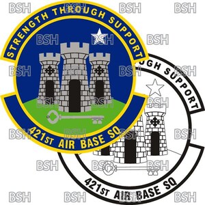 May include: A blue and yellow circular patch with a white star and three grey towers. The text "Strength Through Support" is written around the top of the circle. The text "421st Air Base Sq" is written around the bottom of the circle.