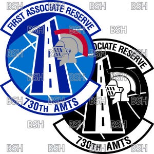 May include: Two military patches. One is blue with white and red accents, featuring text "FIRST ASSOCIATE RESERVE" and "730TH AMTS", and a helmeted figure. The other is black and white with similar design elements.