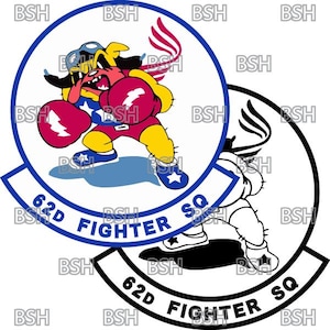 May include: A white circle with a blue border and the text "62D Fighter SQ" in blue. Inside the circle is a cartoon image of a yellow dog wearing boxing gloves and a red, white, and blue boxing outfit. The dog is throwing a red boxing glove with a lightning bolt on it. The dog is standing on a blue and white cloud. The circle is surrounded by a white background.