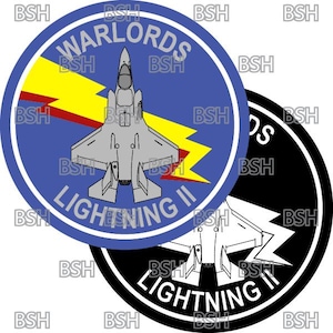 May include: Two circular patches featuring a fighter jet design. One patch is blue with the text "WARLORDS LIGHTNING II" and a yellow lightning bolt. The other patch is black and white with the same jet and text.