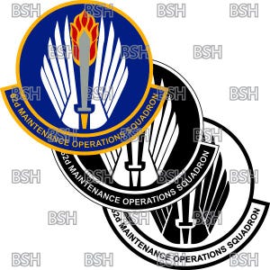 May include: A black and white emblem featuring a stylised eagle and a sword. The emblem is encircled by a circle with the text "62d MAINTENANCE OPERATIONS SQUADRON".
