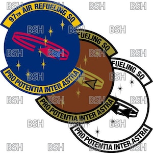 May include: Three military patches with the text "97th Air Refueling SQ" and "Pro Potentia Inter Astra". The patches are blue, brown, and black, each with a unique design featuring a stylized aircraft and stars.