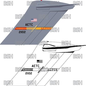 May include: A black and white illustration of a plane with the text "AETC" and "ALTUS" on the tail. The tail also has the number "21102" on it.