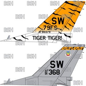 May include: A close-up of a fighter jet tail with a tiger stripe design. The tail is orange and black with the words "TIGER TIGER!" and "79FS" on it. The tail also has a "SW" marking and the serial number "AF 910379".