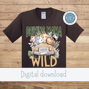 May include: A dark brown t-shirt featuring a safari-themed graphic. The design includes the text "DRIVING MAMA WILD" above a cartoon jeep filled with animal characters. A circular logo is in the upper right corner.