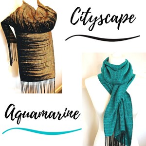 May include: Two woven scarves with fringe. The first scarf is black and gold with a geometric pattern. The second scarf is teal blue with a geometric pattern. The text "Cityscape" is above the first scarf and the text "Aquamarine" is below the second scarf.