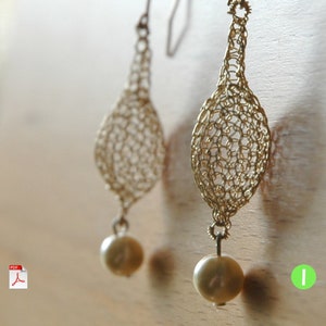 May include: Gold wire earrings with a delicate, crocheted design and a pearl drop.