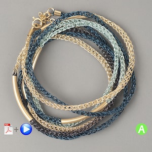 May include: A set of six gold, blue, and green wire bracelets with a gold bar accent. The bracelets are layered and create a multi-dimensional look.