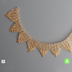 以下が含まれることがあります： 繊細なチェーンとつながった三角形のデザインが施されたゴールドネックレス。ネックレスは金属製で、光沢のある仕上げです。