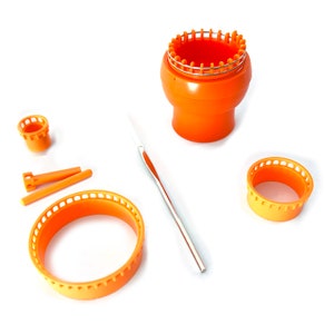 May include: Orange knitting loom set with a variety of sizes and a crochet hook. The set includes a round loom, two smaller looms, and two knitting needles.