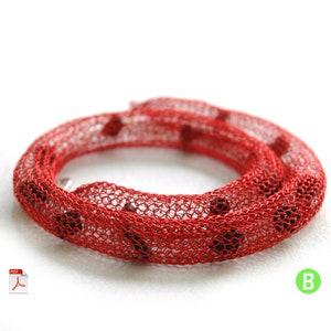 May include: Red wire mesh necklace with black beads. The necklace is coiled and laid on a white surface.