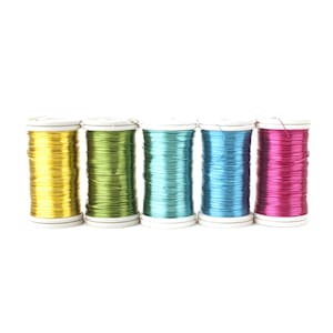 May include: Five spools of metallic wire in different colours: gold, green, teal, blue, and pink. The spools are all the same size and have white plastic caps.
