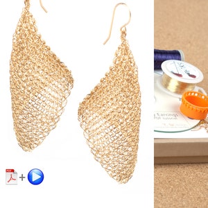 May include: A pair of gold-colored earrings made of woven wire mesh. The earrings are shaped like a teardrop and have a delicate, intricate design. The earrings are shown against a white background.