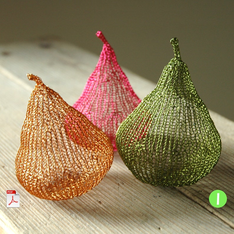 May include: Three crocheted pear-shaped ornaments in pink, green, and gold. The ornaments are made of wire and have a delicate, lacy texture.