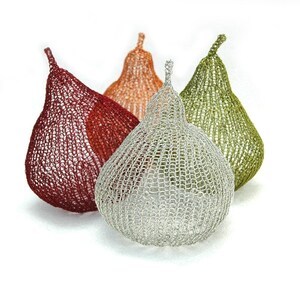 May include: Three knitted pear-shaped sculptures in red, orange, and green.