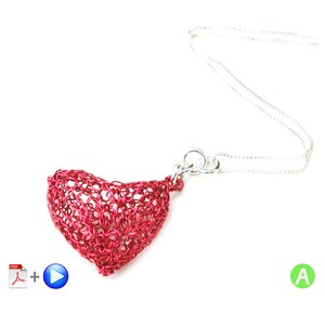 May include: A red heart-shaped pendant necklace made of wire mesh, hanging from a silver chain.