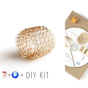 May include: Gold wire ring DIY kit with instructions. The kit includes a spool of gold wire, a needle, and a PDF tutorial. The finished ring is a delicate, intricate design.