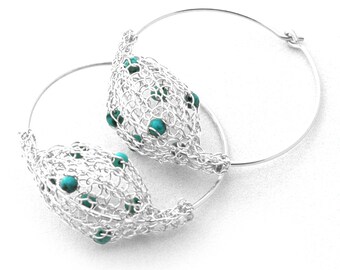 May include: Silver hoop earrings with a delicate wire mesh design and turquoise beads.