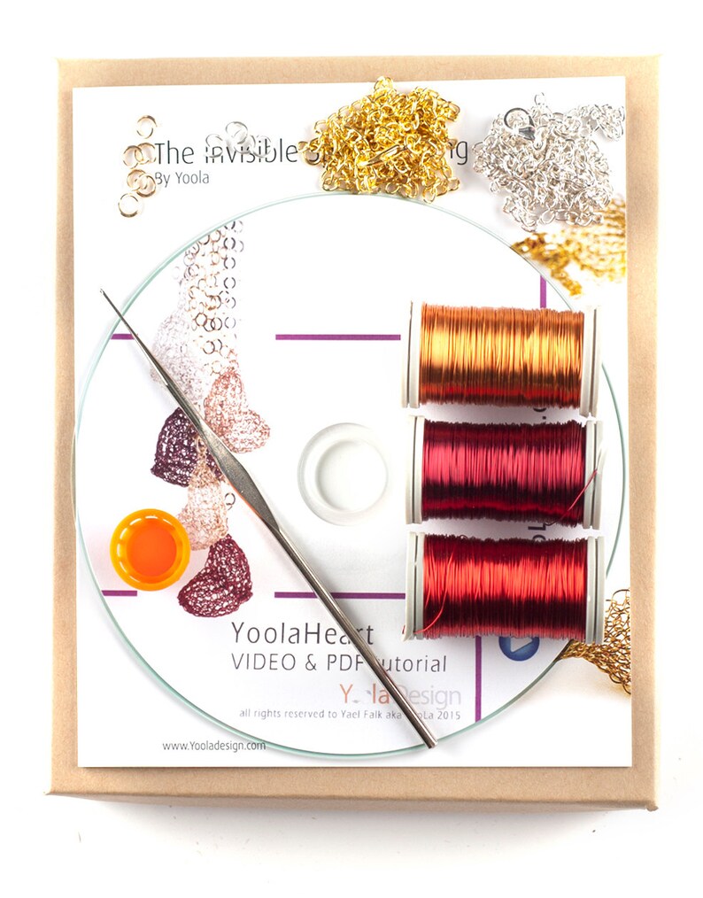 May include: A craft kit for making jewelry, featuring a CD, three spools of red wire, two piles of gold and silver chain, and a small orange bottle. The CD label reads "YoolaHeart VIDEO & PDF tutorial Y-la Design all rights reserved to Yael Falk aka La 2015 www.Yooladesign.com".