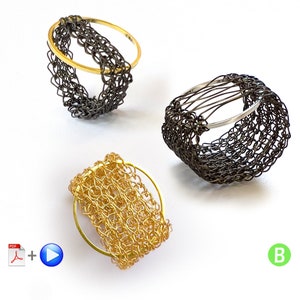 May include: Three wire rings, one gold, one silver, and one black, are woven into intricate patterns. The rings are displayed on a white surface.