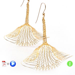 May include: A pair of gold-toned earrings with a delicate, intricate design. The earrings are made of a woven wire mesh that creates a unique and eye-catching look.
