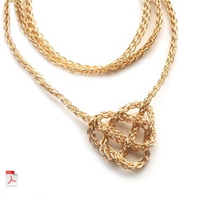 May include: A gold chain necklace with a knotted pendant. The chain is made of multiple strands of braided wire.