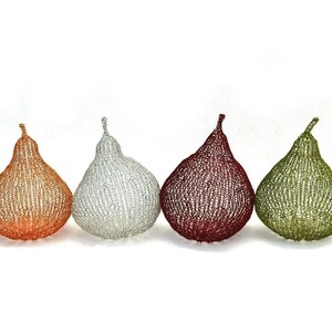 May include: Four pear-shaped knitted ornaments in different colors: orange, silver, red, and green.