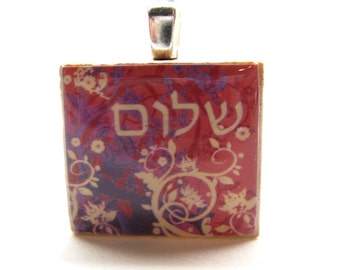 Hebrew Scrabble tile pendant - Shalom - Living peace - with leafy background in pinks and purples - Jewish jewelry