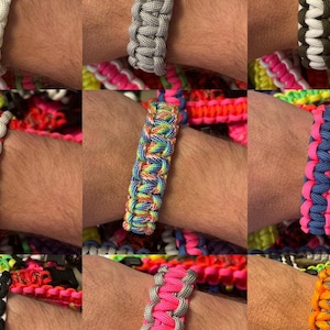 May include: A collection of colorful paracord bracelets with various patterns and color combinations. The bracelets are made with a woven technique and feature different colors like red, white, blue, green, yellow, orange, black, and pink.