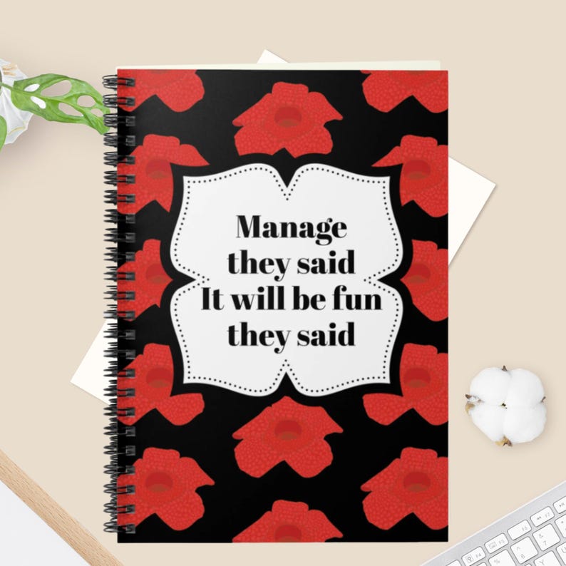 Boldly designed notebook for the workplace, combining humor and function for busy managers.
