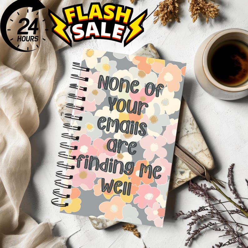 Może przedstawiać: Szary notes spiralny z kwiatowym wzorem i tekstem "None of your emails are finding me well".