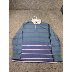 May include: A long-sleeved rugby shirt with horizontal stripes in teal, blue, and light pink. The shirt has a white collar and a button-up placket. The cuffs are solid teal.