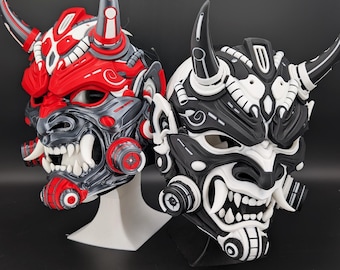 May include: Two detailed Oni masks, one red and gray, the other black and white. Both masks feature sharp teeth, horns, and intricate mechanical-style designs. The masks are displayed on stands against a neutral background.