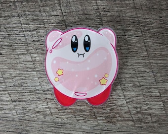 May include: A pink and white cartoon character with large blue eyes, a small mouth, and red feet. The character has a round body with small ears and is decorated with yellow stars.