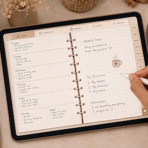 May include: A digital tablet displaying a weekly planner interface with handwritten text including 'Weekly Focus', 'Top Priorities', and 'Affirmation'. The screen shows a grid layout with tabs for Home, Monthly, Weekly, Daily, and Notes, alongside a stylus.