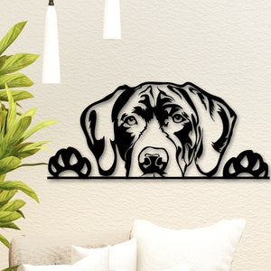 May include: Black metal wall art of a dog's head peeking over a surface with paws on either side.