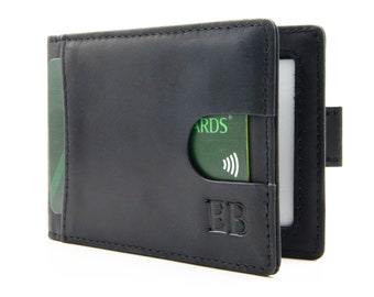May include: Black leather wallet with a money clip and a card slot. The wallet has a small logo that says "EB" on the front.