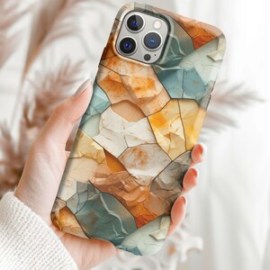 May include: A phone case with a colorful abstract pattern of broken stone in shades of blue, brown, white, and yellow.