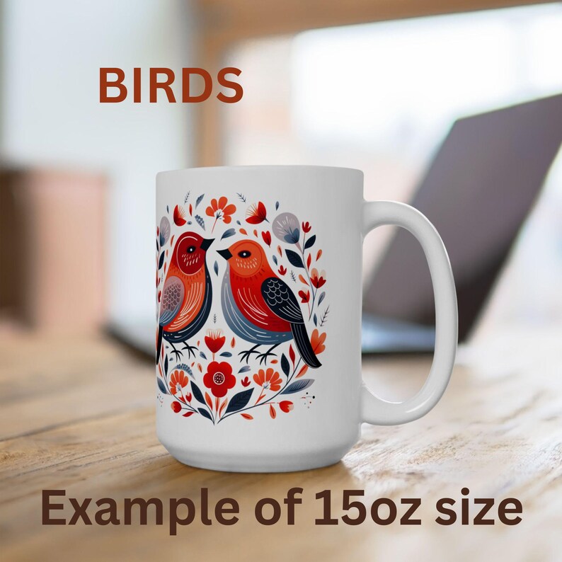 May include: White ceramic mug with a colorful illustration of two birds and floral designs. The mug is 15 ounces and says "BIRDS" in brown text at the top.