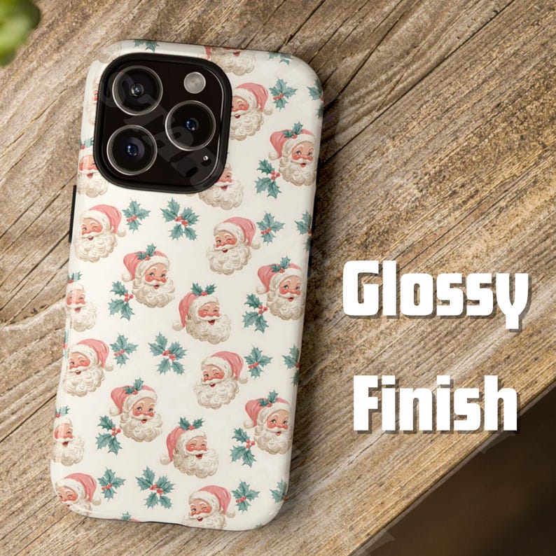 May include: A white phone case with a glossy finish, featuring a repeating pattern of Santa Claus faces in pink hats and holly sprigs. The case is on a wooden surface. The text "Glossy Finish" is visible.